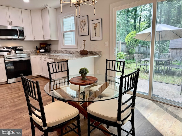 1410 Foxwood Ct, Annapolis, MD 21409 - dining space featuring light wood finished floors, a chandelier, and recessed lighting
