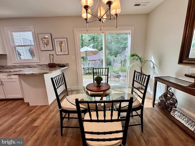 1410 Foxwood Ct, Annapolis, MD 21409 - dining area with a chandelier, wood finished floors, and baseboards
