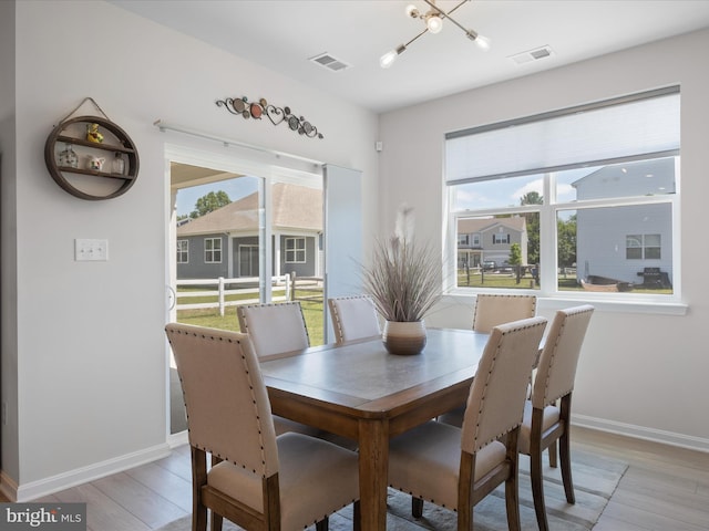 832 Red Maple Rd, Smyrna, DE 19977 - dining room with light wood-style flooring, baseboards, and a chandelier