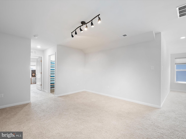 832 Red Maple Rd, Smyrna, DE 19977 - spare room featuring carpet, baseboards, and rail lighting