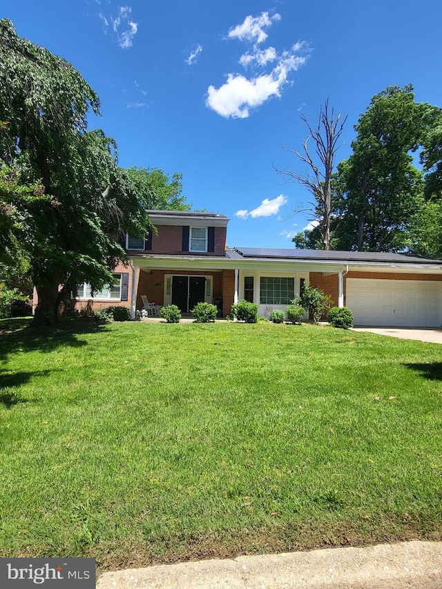 7100 Beltz Dr, District Heights, MD 20747 - traditional-style home with an attached garage, a front yard, roof mounted solar panels, driveway, and brick siding