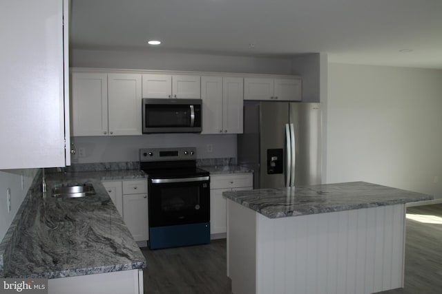1296 Dorchester Ave, Pocomoke City, MD 21851 - kitchen featuring stainless steel appliances, wood finished floors, white cabinets, light stone counters, and recessed lighting