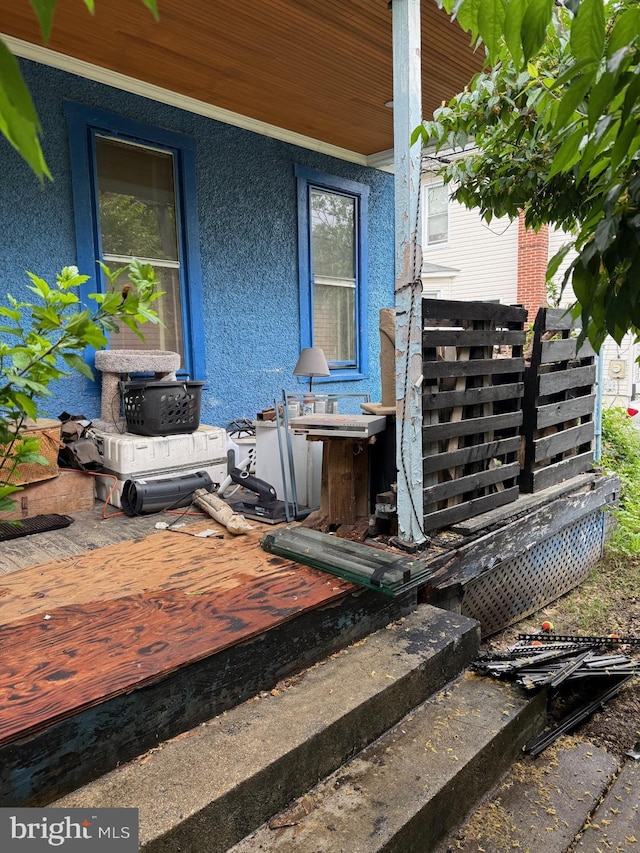 exterior view of stucco siding and a wood stove