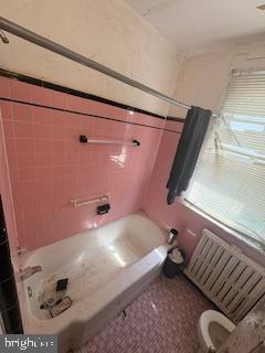 full bath with radiator heating unit and toilet