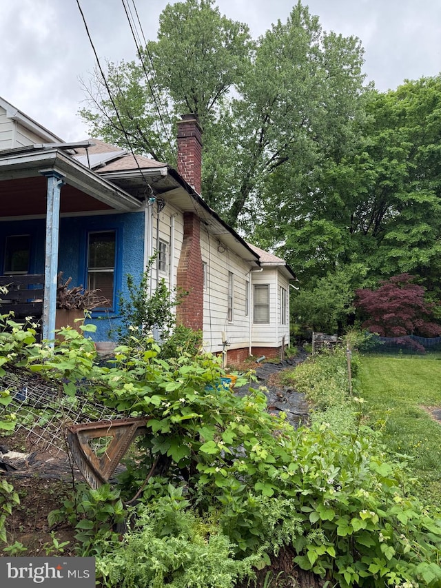 view of side of home with a chimney