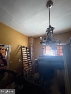 miscellaneous room with a chandelier