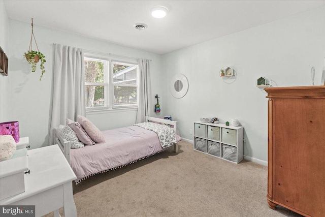 carpeted bedroom featuring baseboards