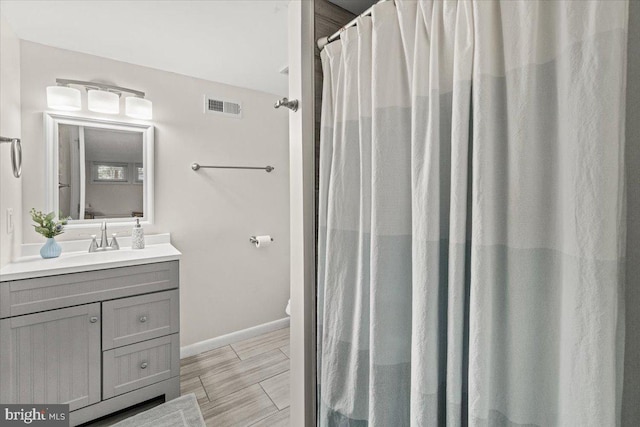 bathroom featuring vanity and baseboards
