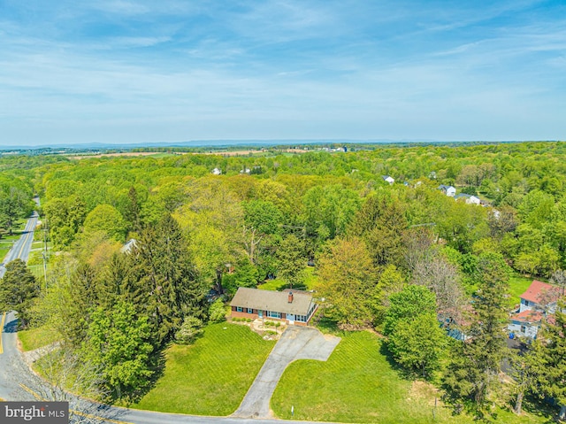 view from above of property with a heavily wooded area