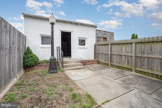 519 N 2nd St, Columbia, PA 17512 - back of property featuring a fenced backyard, concrete block siding, and a patio