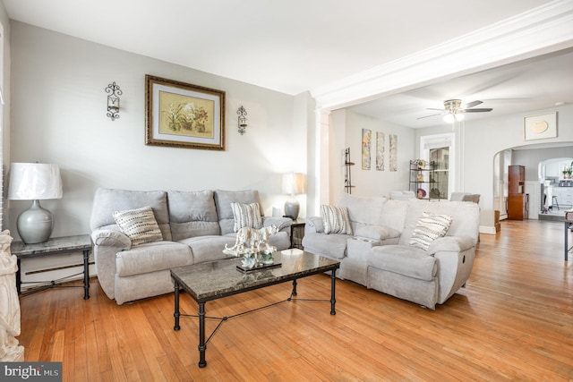 519 N 2nd St, Columbia, PA 17512 - living room with wood finished floors, arched walkways, a baseboard heating unit, and a ceiling fan