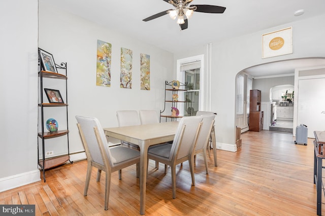 519 N 2nd St, Columbia, PA 17512 - dining space featuring arched walkways, ceiling fan, light wood-style flooring, and baseboards