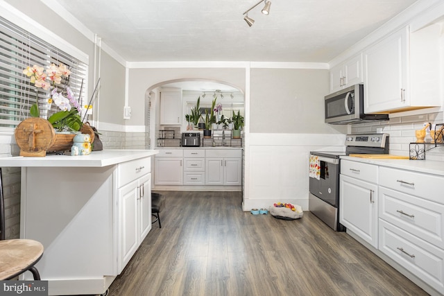 519 N 2nd St, Columbia, PA 17512 - kitchen featuring stainless steel appliances, white cabinets, light countertops, dark wood-style floors, and wainscoting