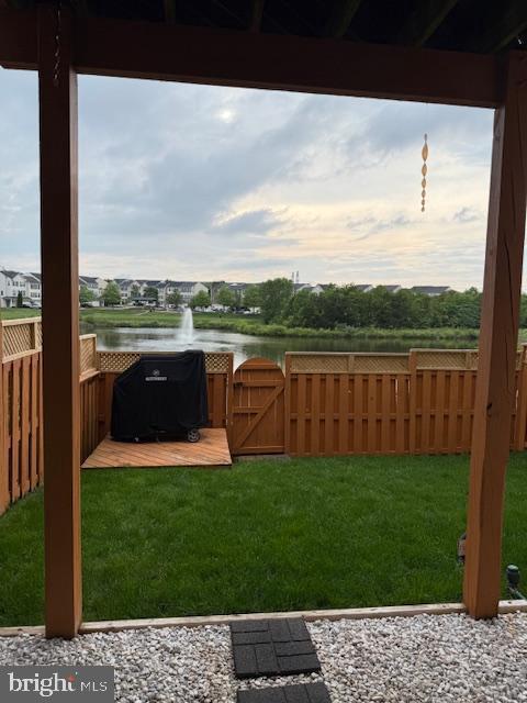 view of yard with a water view and a gate