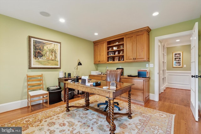 office with recessed lighting and light wood-style floors