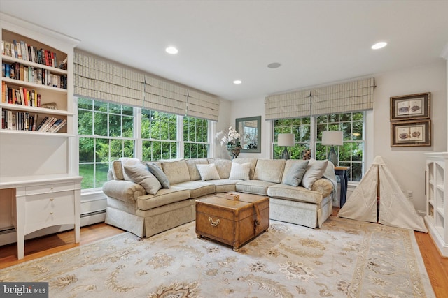living room with wood finished floors, healthy amount of natural light, and recessed lighting