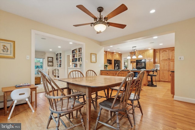 dining space featuring light wood-type flooring, recessed lighting, a ceiling fan, and baseboards
