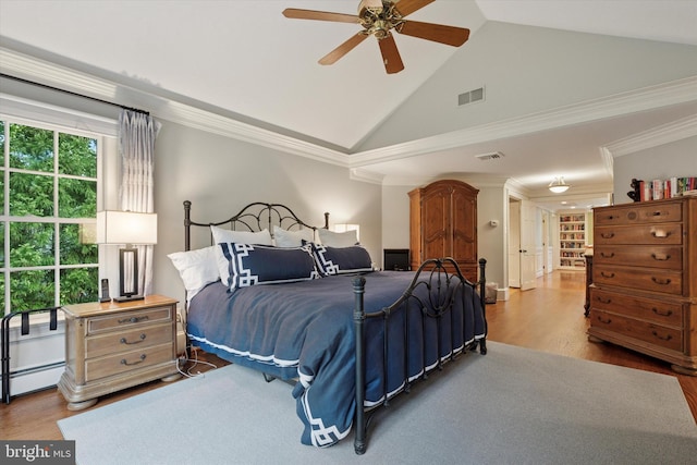bedroom with wood finished floors, high vaulted ceiling, ceiling fan, ornamental molding, and baseboard heating