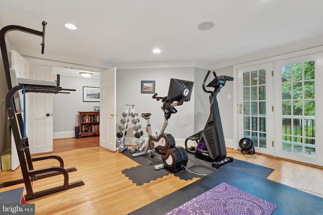 exercise room with ornamental molding, wood finished floors, baseboards, and recessed lighting