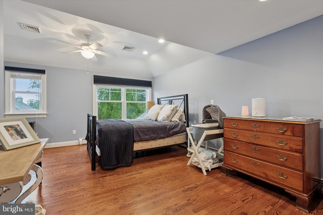 bedroom featuring lofted ceiling, wood finished floors, baseboards, ceiling fan, and a baseboard radiator