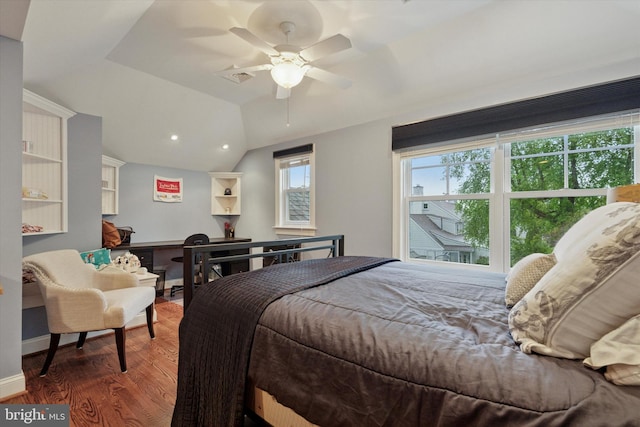 bedroom featuring wood finished floors, lofted ceiling, and a ceiling fan