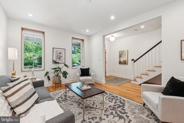 living area featuring wood finished floors, stairs, recessed lighting, and baseboards