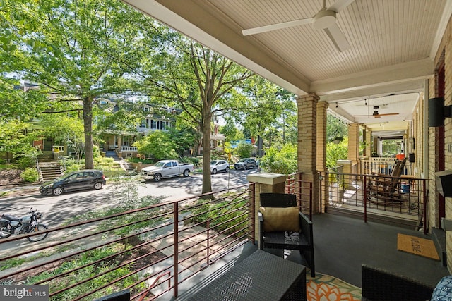 balcony with ceiling fan and a porch