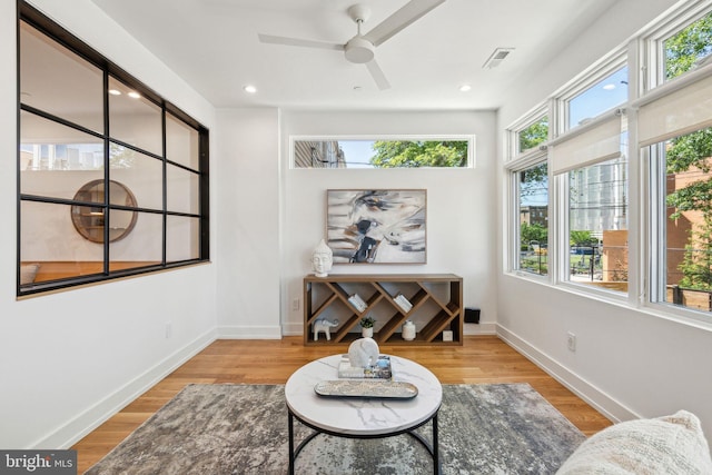 sitting room featuring wood finished floors, ceiling fan, baseboards, and recessed lighting