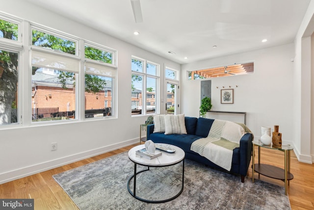 living area featuring baseboards, recessed lighting, wood finished floors, and a ceiling fan