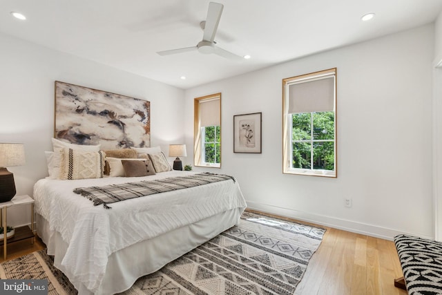 bedroom featuring wood finished floors, recessed lighting, baseboards, and ceiling fan
