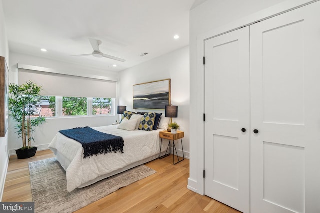 bedroom with light wood-style flooring, recessed lighting, a closet, baseboards, and a ceiling fan
