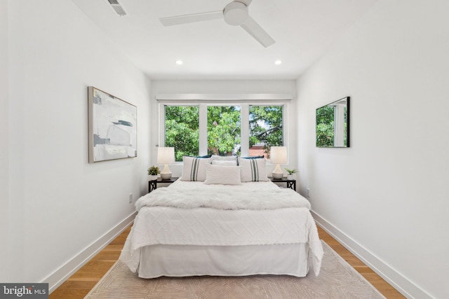 bedroom featuring light wood-type flooring, baseboards, recessed lighting, and a ceiling fan
