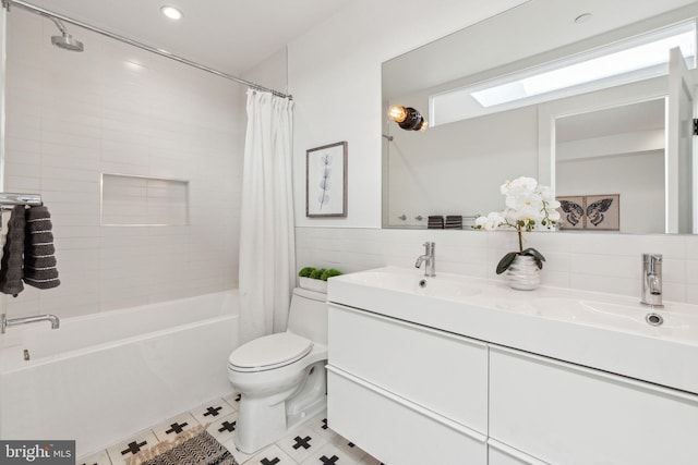 bathroom with toilet, shower / bath combination with curtain, double vanity, a skylight, and tile patterned floors