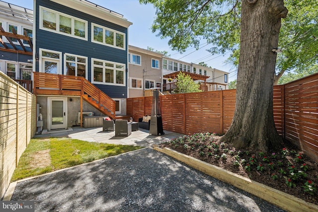 rear view of house featuring a patio area and a fenced backyard