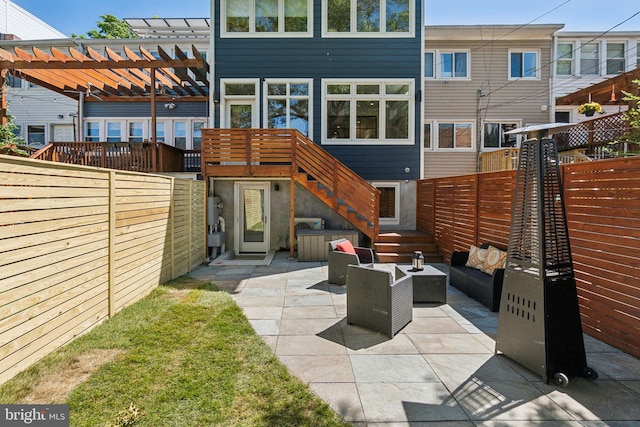 rear view of house with a fenced backyard, a patio area, outdoor lounge area, and a pergola