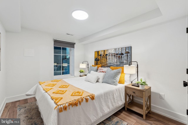 bedroom with wood finished floors and baseboards