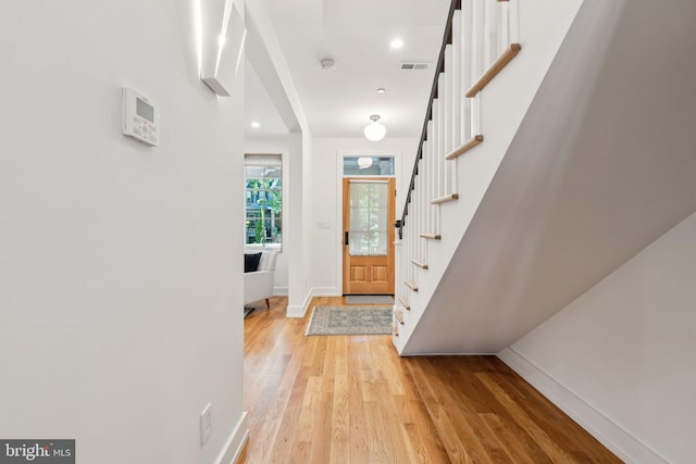 entrance foyer featuring baseboards, light wood-style flooring, stairway, and recessed lighting