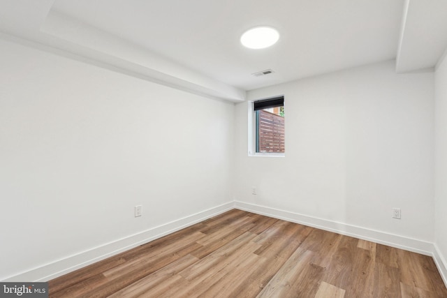 spare room with light wood-type flooring and baseboards