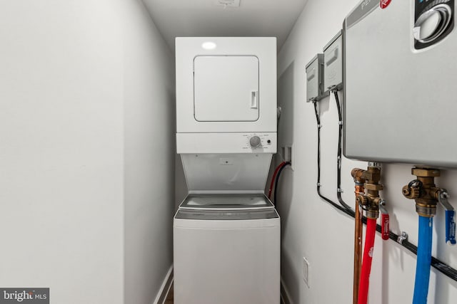 laundry area featuring stacked washer / drying machine