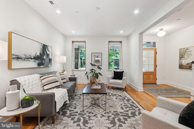 living room with wood finished floors, recessed lighting, and baseboards