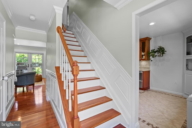 7029 Leewood Forest Dr, Springfield, VA 22151 - stairs with crown molding, french doors, recessed lighting, and tile patterned floors