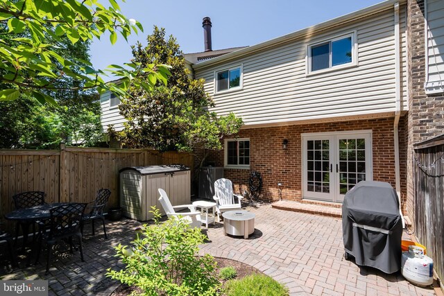 7029 Leewood Forest Dr, Springfield, VA 22151 - fenced backyard with french doors, a patio area, a jacuzzi, and outdoor dining area