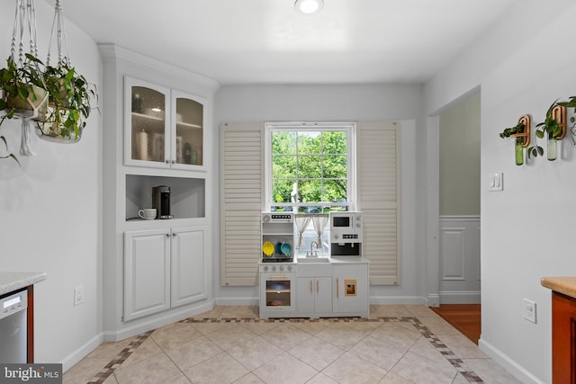 7029 Leewood Forest Dr, Springfield, VA 22151 - unfurnished dining area featuring inlaid floor details, light tile patterned flooring, baseboards, and a sink