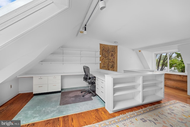 office space with lofted ceiling and wood finished floors