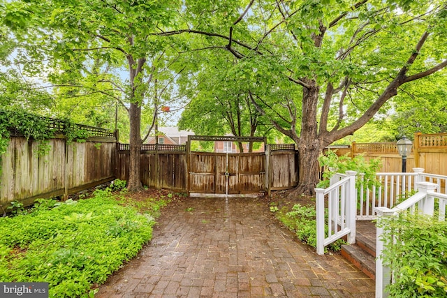 fenced backyard with a gate