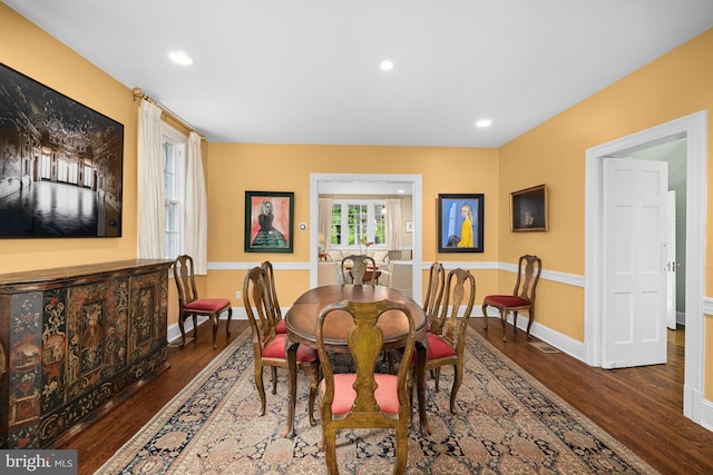 dining space featuring wood finished floors, baseboards, and recessed lighting