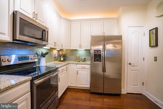 kitchen with stainless steel appliances, dark wood finished floors, white cabinetry, and tasteful backsplash