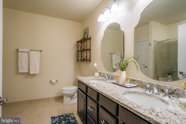 full bathroom featuring toilet, tiled shower, double vanity, baseboards, and tile patterned floors