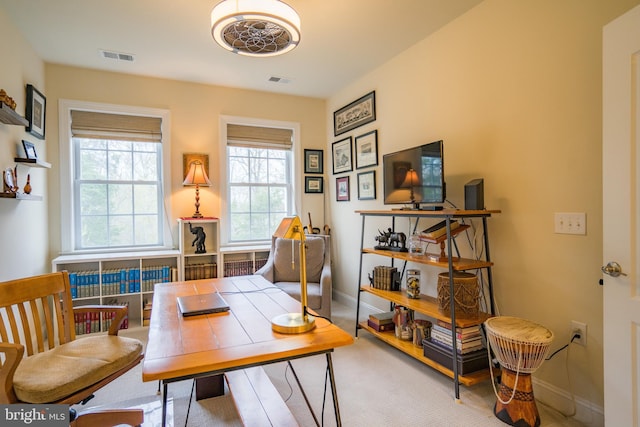 carpeted home office featuring baseboards