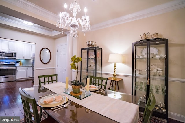 dining room featuring ornamental molding, a chandelier, and dark wood-type flooring